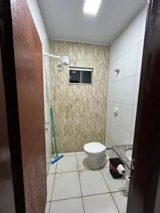 a bathroom with a toilet and a shower in it at Lar doce lar in Barra do Garças