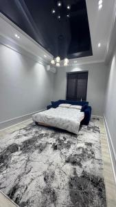 a bedroom with a bed and a large rug at Lux apartment in Ak-Tyube