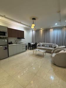 a living room with a couch and a table at أوركيد بالاس للشقق المخدومة in Riyadh