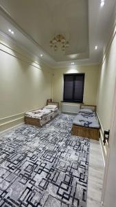 a room with two beds and a large rug at Lux apartment in Ak-Tyube +1 photo