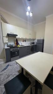 a kitchen with a table and a counter in it at Lux apartment in Ak-Tyube