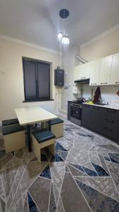 a large kitchen with a table and a counter at Lux apartment in Ak-Tyube