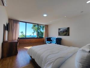 a bedroom with a large bed and a large window at Villa Mirasol Hotel in Tangier +125 photos