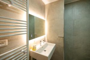a bathroom with a sink and a mirror at Hotel Petro in Vlorë +48 photos