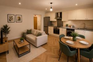 a kitchen and living room with a table and a couch at Ai Stays Bentcliffe Suites in Moortown