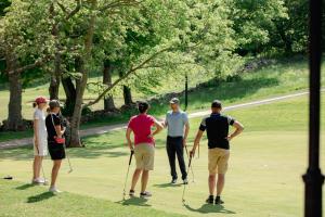 a group of people playing golf on a golf course at Kullagård Hotell in Mölle