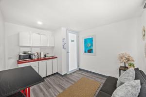 a living room with a couch and a kitchen at Downtown Studio at San Juan JL Guaynabo in San Juan