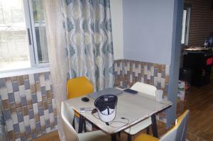 a table and chairs with acomputeropter on top of it at Grand Studio à 200 m de la plage de Kribi Clim - Wi-Fi in Kribi