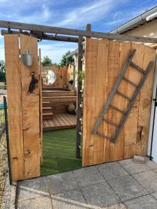 a wooden gate with a black dog on it at Chez Laurie et Xavier studio 4 in Mignaloux-Beauvoir