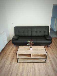 a black couch in a living room with a coffee table at Villa Serenita in Montenau +11 photos