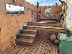 an outdoor sauna with wooden floors and a mirror at Chez Laurie et Xavier studio 4 in Mignaloux-Beauvoir