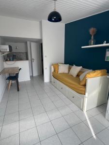 a bedroom with a bed and a blue wall at Chez Laurie et Xavier studio 4 in Mignaloux-Beauvoir