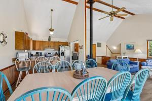 a kitchen and dining room with a table and chairs at The Tree House in Duck