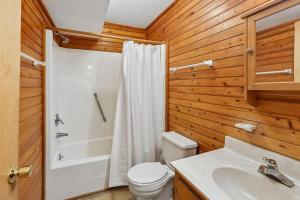 a bathroom with a toilet and a shower and a sink at The Tree House in Duck +29 photos