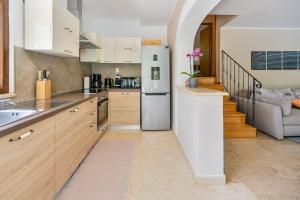 a kitchen with a stainless steel refrigerator and a staircase at Villa Ferlini in Ferlini