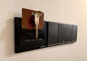 a wall mounted object with a key in a wallet at Araliya Hotel in Badulla