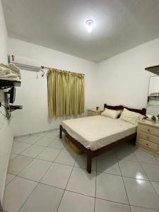 a bedroom with a bed in a room at Casa de Praia com Piscina e Espaço Gourmet in Bertioga +16 photos
