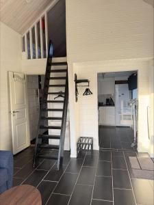 a room with a staircase and a kitchen at Brygghuset between Hjo and Tidaholm in Hjo