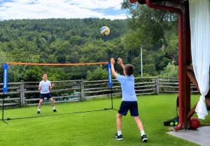 two young people playing a game of volley ball at Panorama Dream Studios B in Vourvourou