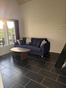 a living room with a couch and a coffee table at Brygghuset between Hjo and Tidaholm in Hjo +1 photo