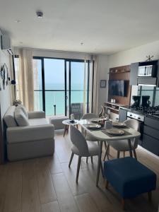a living room with a table and chairs and a kitchen at Brand NEW! Ocean front,City 360Views 26FL,FREE Airport pick up by IMZ in Cartagena de Indias