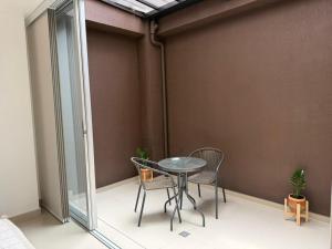 a balcony with a table and two chairs on it at Las Lilas - 102 in Cali