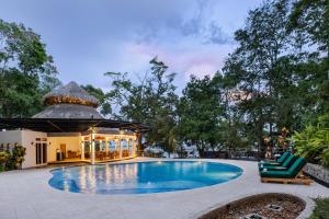 a swimming pool in a yard with a gazebo at Bolontiku Boutique Hotel Member of the Cayuga Collection in Flores