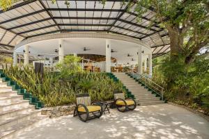 a building with three chairs and a staircase at Bolontiku Boutique Hotel Member of the Cayuga Collection in Flores