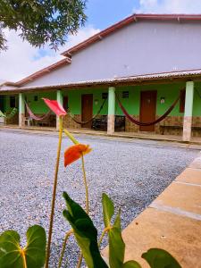 a building with a red flower in front of it at Bom Viver Pousada ltda in Viçosa do Ceará