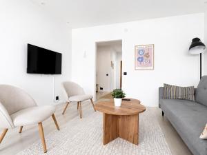 a living room with a couch and a table at Galle's 2 bedroom penthouse in Pori