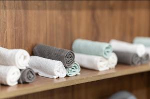 a row of rolled towels on a shelf at جناح اميري in Ash Shishah