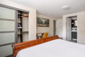 a bedroom with a bed and a desk at Cozy Coastal Retreat Close to Beach Park in Port Moody