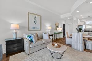 a living room with a couch and a table at Sea Gate 303 in Saint Simons Island