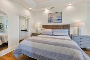 a bedroom with a large bed and two lamps at Sea Gate 303 in Saint Simons Island +20 photos