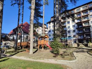 a playground in front of a apartment building at Titova vila apartman Vardar 17 in Palisat
