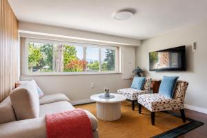 a living room with two couches and a window at Cozy Coastal Retreat Close to Beach Park in Port Moody