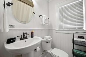 a bathroom with a sink and a toilet and a mirror at Historic Riverview Inn One in Chattanooga