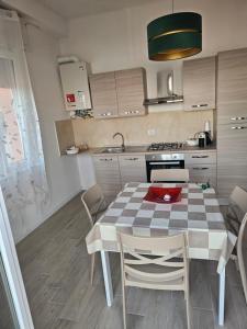 a kitchen with a table and chairs in a room at palombina vista mare in Ancona