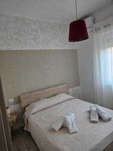 a bedroom with a bed with two towels on it at palombina vista mare in Ancona