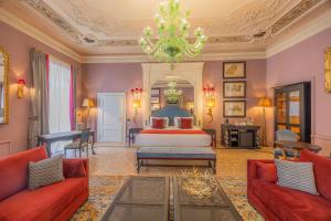 a bedroom with a bed and two red couches at Palazzo Trezza in Verona