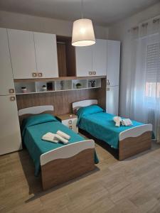 a bedroom with two beds and a light at palombina vista mare in Ancona