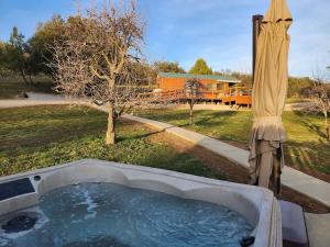 a bath tub in a yard with an umbrella at The Couple's Cabin in Wynola 2 NIGHT MINIMUM in Julian