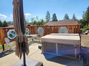an umbrella and a bed on a patio at The Couple's Cabin in Wynola 2 NIGHT MINIMUM in Julian