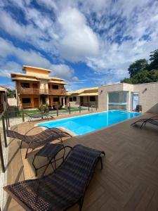 a patio with chairs and a swimming pool at Pousada Cipó Cana in Santana do Riacho