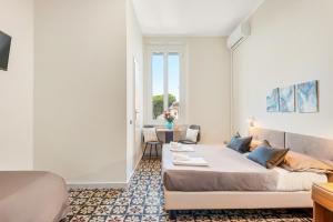 a hotel room with a bed and a table at Hotel La Perla in Marina di Massa +54 photos