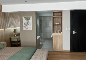 a bedroom with a bed and a bathroom at Empire Hotel Buenos Aires in Buenos Aires +71 photos