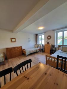 a large room with two beds and a table at Studio in Fürstenfeld