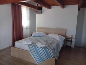 a bedroom with a bed with a striped blanket at Casa Dora in Porto Pino