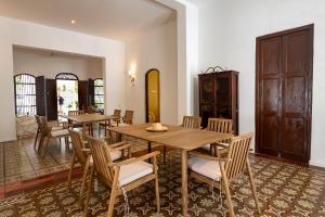 a dining room with wooden tables and chairs at Cabrero House Boutique in Cartagena de Indias +23 photos
