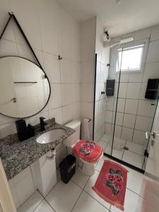 a bathroom with a toilet and a sink and a shower at Lazer Oceanos in São Vicente +6 photos